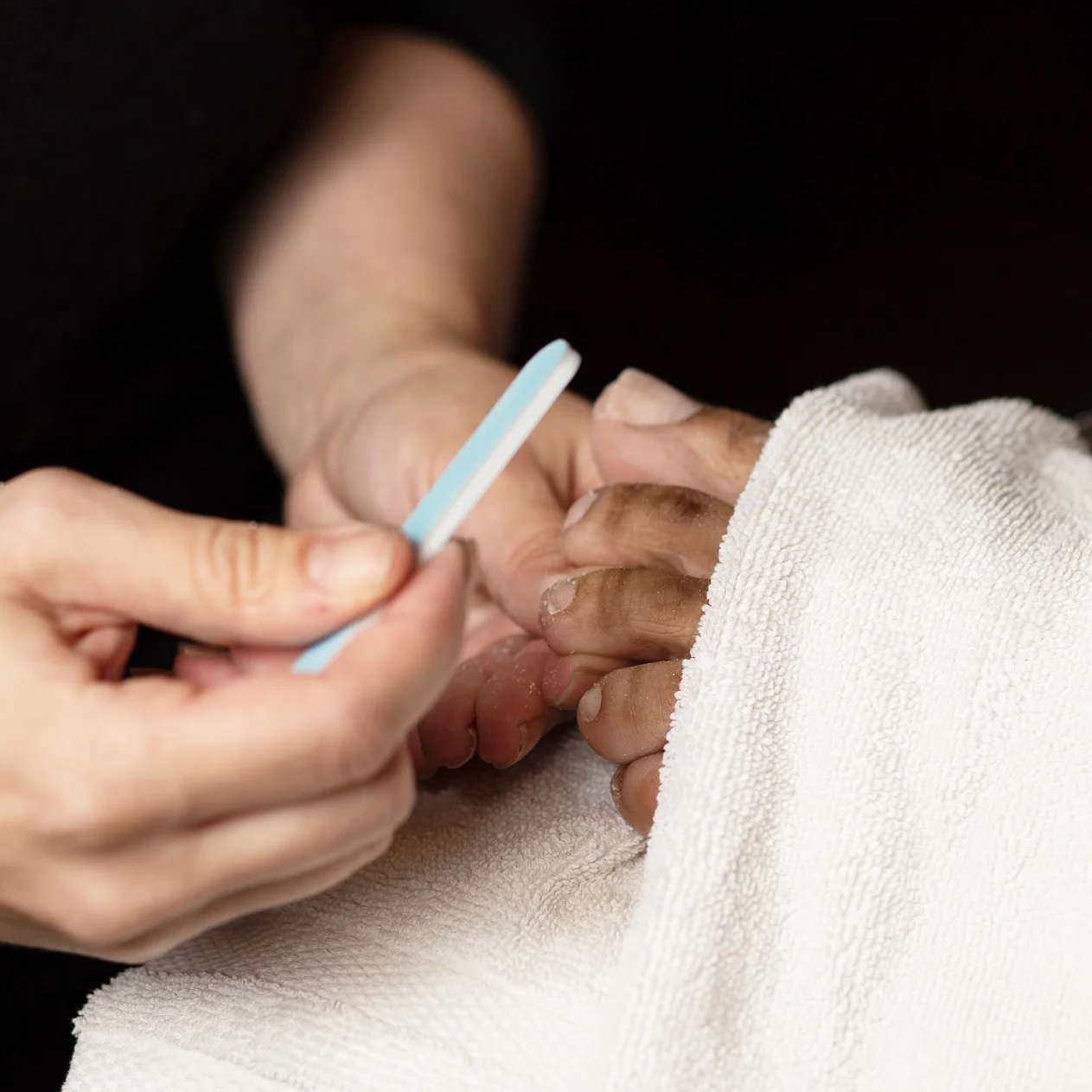Toe nails are filed during a pedicure