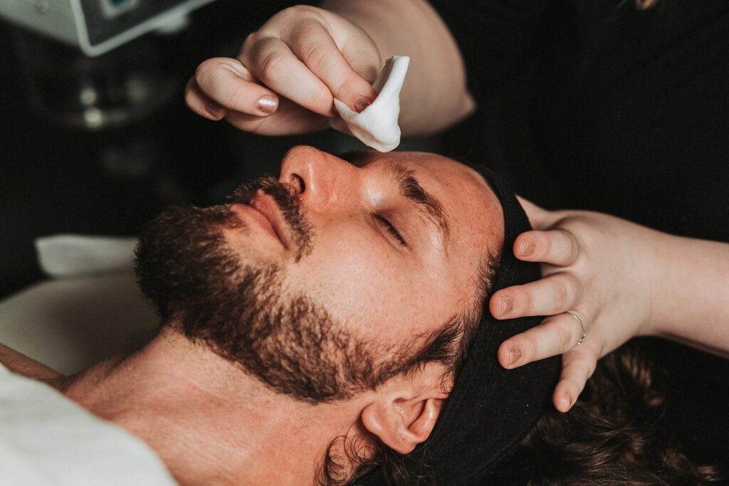 A man with a beard receives a facial treatment